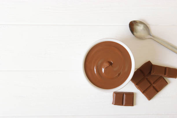 istock chocolate paste in a glass jar on a colored background. 1314078605