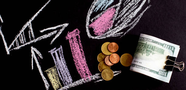 istock Marketing strategy concept hand drawn on black blackboard with dollars and coins 1314083761