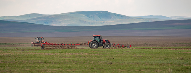 Plowing at field with tractors