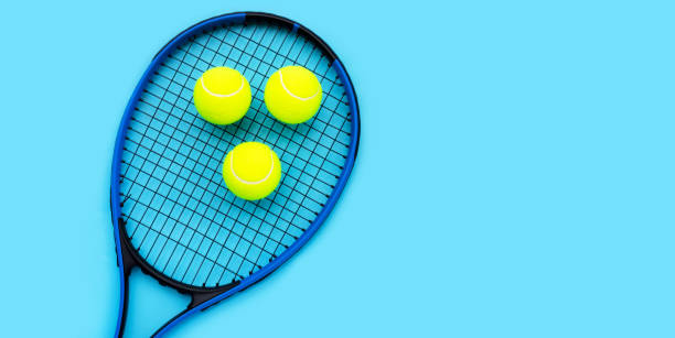 istock Tennis racket with balls on blue background. 1314085036