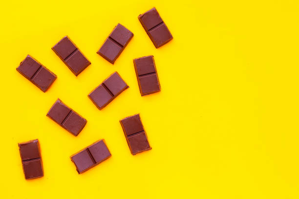 istock Chocolate bar isolated on yellow background 1314085108