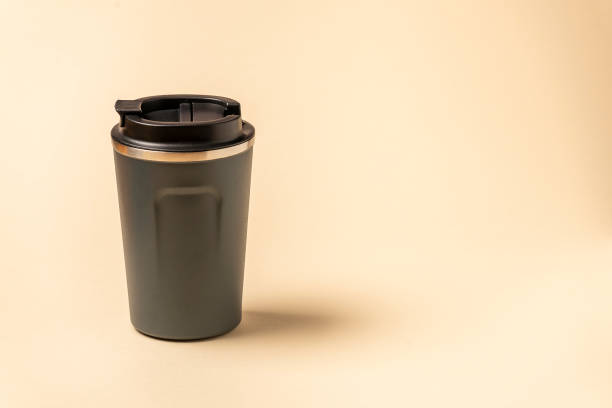 istock Reusable plastic mug with silicone holder isolated on natural shade beige background. 1314085234