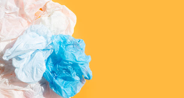 istock Crumpled plastic bags on orange background. 1314086846