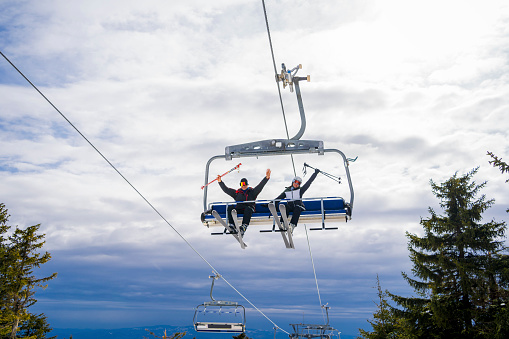 Happy couple in chairlift at ski resort