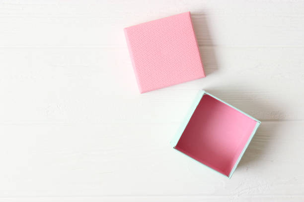 istock open gift box and confetti on a colored background top view. 1314091271