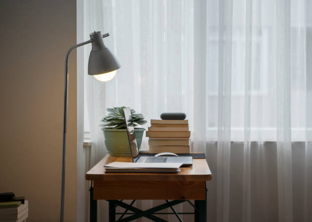 istock Simple home office setup with a table and laptop 1314092138