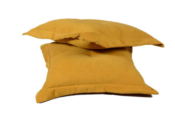 istock two yellow cushions for the sofa. isolated on white, copy space. 1314092821