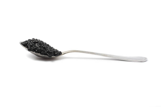 colher de metal com caviar preto. isolado em fundo branco. - heap caviar animal egg fish roe - fotografias e filmes do acervo