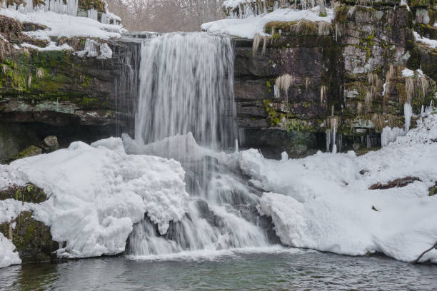 istock Amazing, powerful waterfall covered with snow and icicles during winter season 1314096660