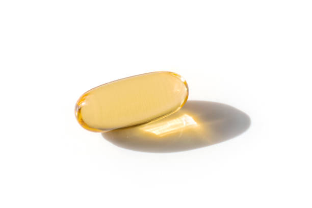 istock Oil filled capsules on the white background 1314099433