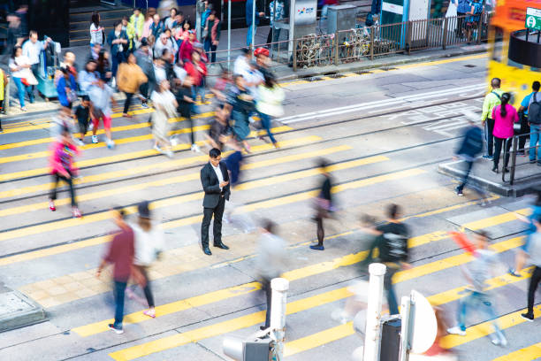 istock Relaxed Chinese Businessman Standing Out From the Crowd 1314100281