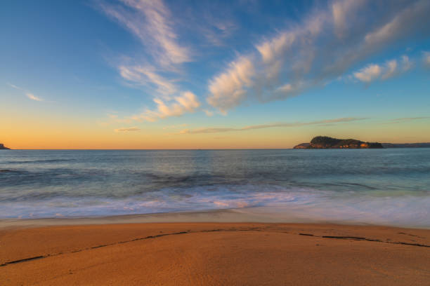 Sunrise seascape and high cloud at North Pearl Beach on the Central Coast, NSW, Australia.