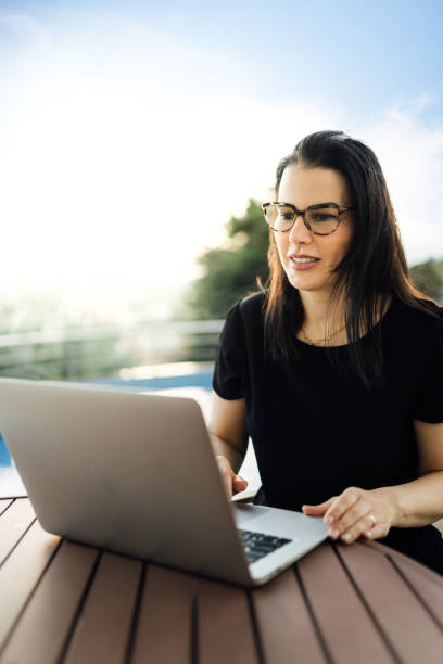 istock Woman using the laptop outdoors 1314103342