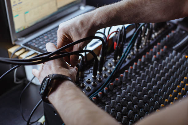 sound engineer plugging jack audio cable on studio mixer. - recording studio sound recording equipment record interconnect imagens e fotografias de stock