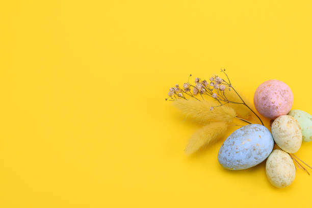 istock Top view of a colorful easter eggs on a yellow background. free space 1314124065