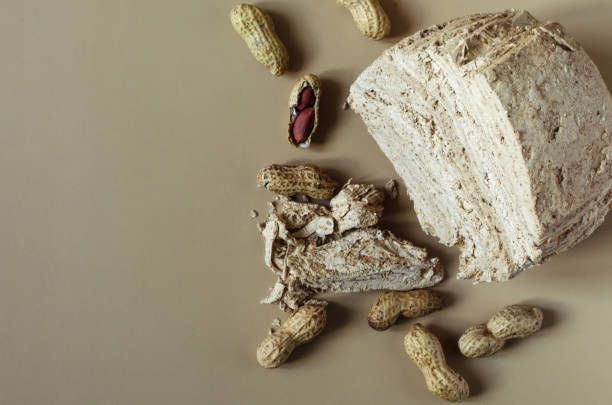 istock Peanut halva and peanut nuts on a light brown background top view of kopi space. Halva oriental sweets 1314124110