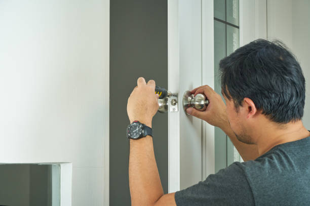 istock locksmith try to fix silver handle with screwdriver for home service by asian man 1314127069