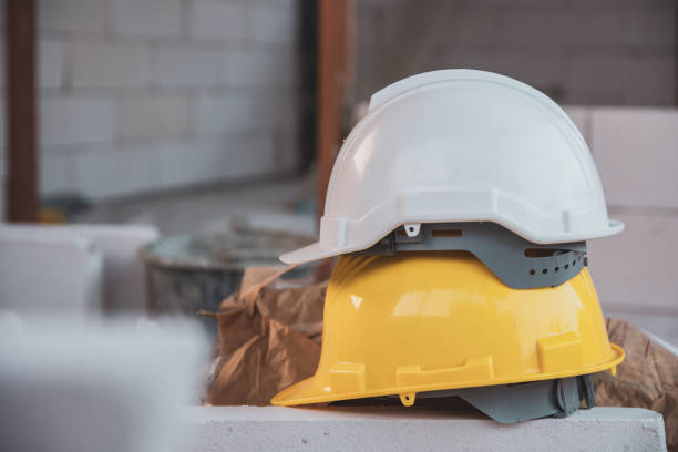 istock White helmet on Yellow helmet hard hat safety 1314128032