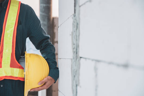 istock Close up Businessman holding yellow hard hat 1314128033