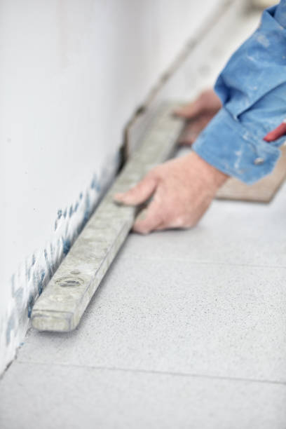 istock Ceramics tile man worker placing new tiles on the floor and wall. 1314128215