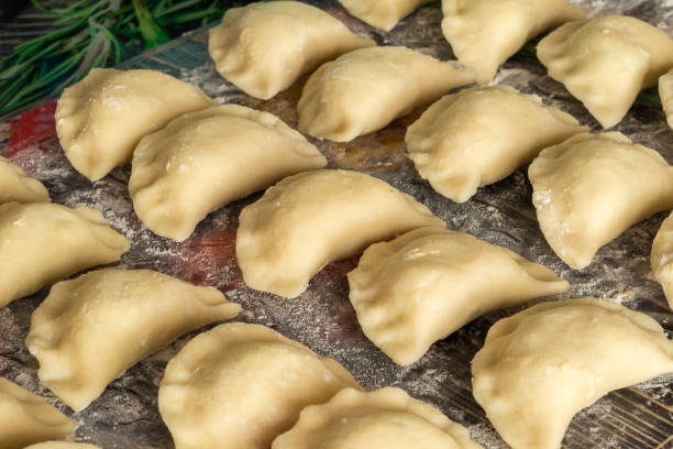 Traditional Polish hand-made dumplings before being boiled Full frame of traditional Polish hand-made dumplings before being boiled pierogi stock pictures, royalty-free photos & images