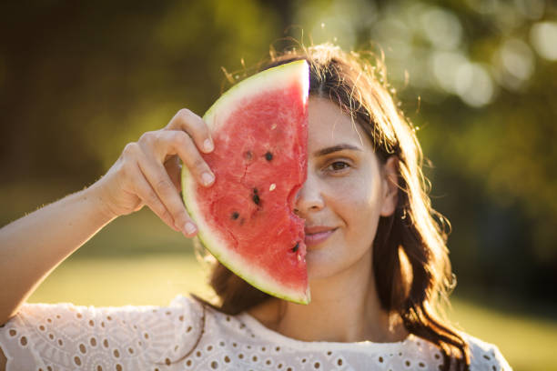 istock Woman holding watermelon looking at camera. 1314131872
