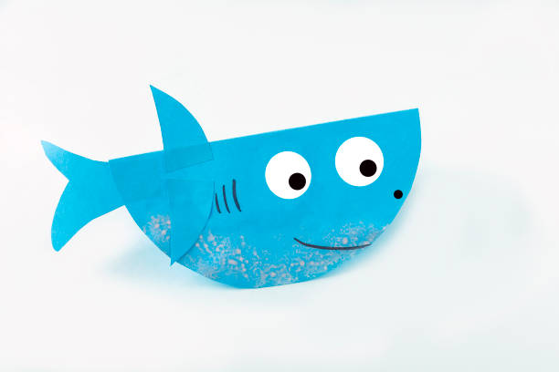 istock DIY and kids creativity. Making shark from paper. Children Craft workshop 1314132509