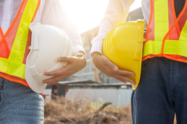 istock Close up businesspeople holding hard hat 1314136659