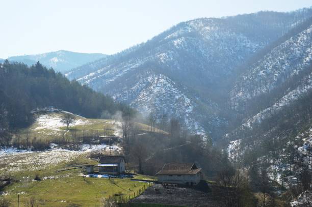 istock mountain farmhouse on a hill with snow in the spring 1314137262