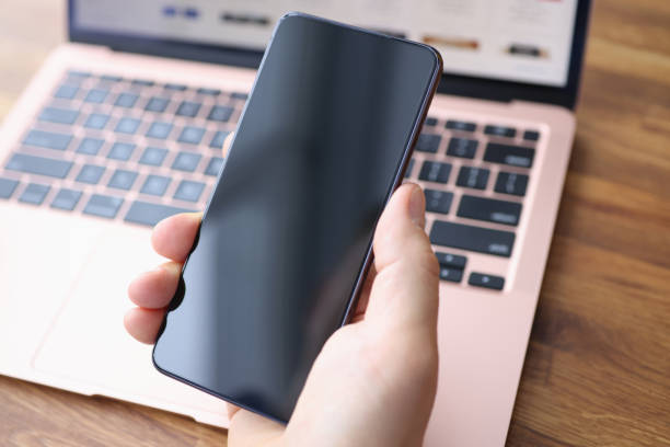 Male hand holding a smart phone.