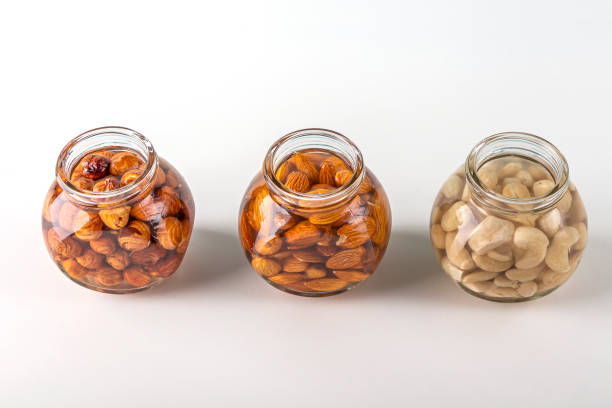 Process of soaking various nuts: almonds, hazelnuts, cashew  in water in glass jar to activate. Home Cooking: making plant based organic veggie Milk, lactose free.