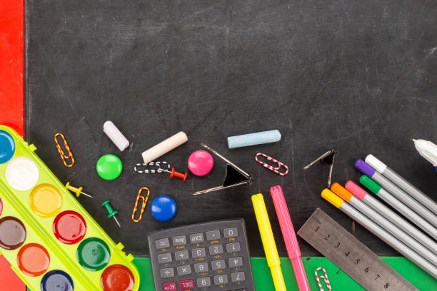 istock School supplies on blackboard background ready for your design. 1314148042