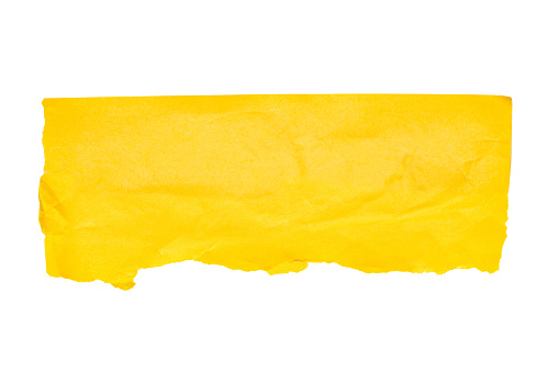 Torn piece of yellow paper on a white background. File contains clipping path. Space for text. Top view.