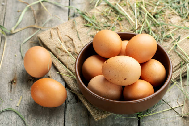 istock Fresh chicken eggs in a clay bowl on the hay. 1314148084