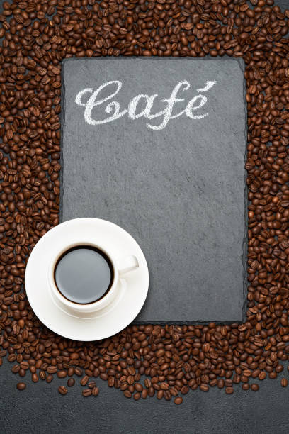 istock Background or texture made of roasted brown coffee beans and stone serving board with chalk handwritten sign 1314149221