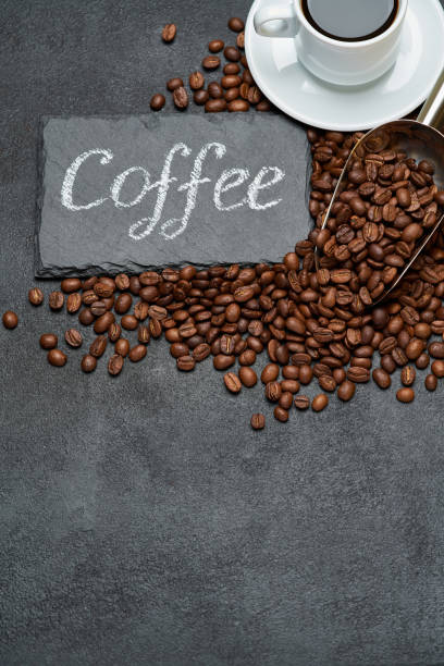 istock Background or texture made of roasted brown coffee beans and stone serving board with chalk handwritten sign 1314149241