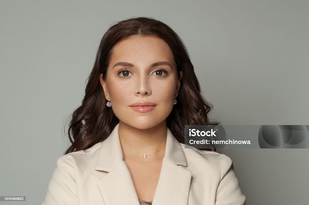 Clever businesswoman on white background portrait Beige Stock Photo