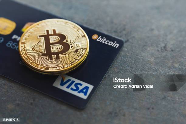 A Bitcoin And A Visa Credit Card On A Textured Background Pay With Cryptocurrencies Wherever You Want In More Than 40 Million Places Around The World Bitcoin As New Money Stock Photo - Download Image Now