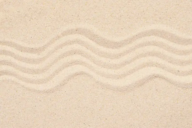 Photo of Sandy texture or background, top view of tropical sand with abstract pattern, lines on the sand.