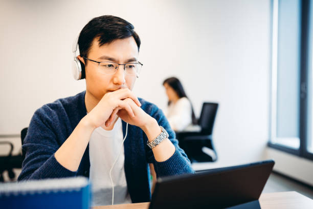 istock Mature Asian man having video call on laptop computer in office. 1314156142