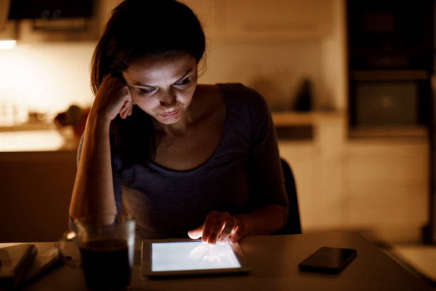 istock Serious mature woman using digital tablet at home 1314157489