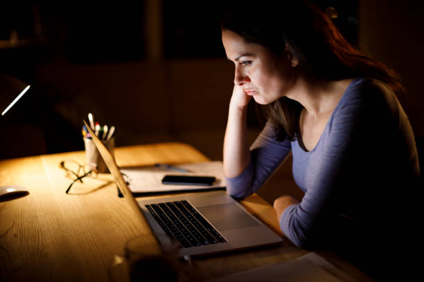 istock Serious mature woman working late at home 1314157647