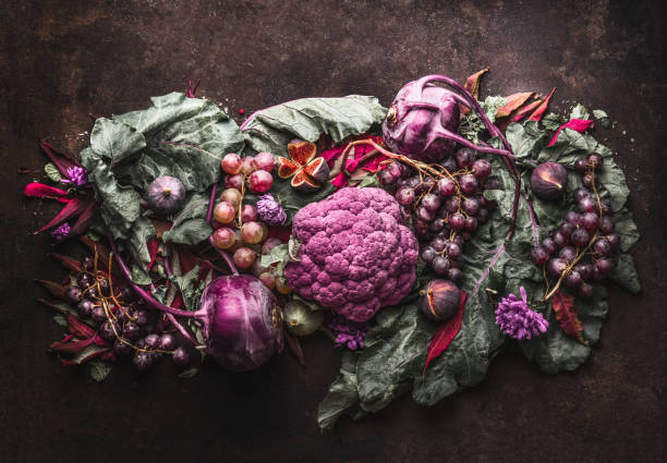 istock Purple fruits and vegetables setting on dark rustic background. Top view. 1314159983