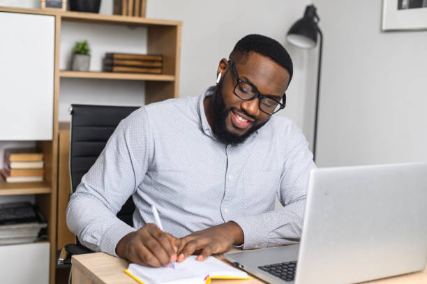 istock Young African-American male student making notes 1314161291