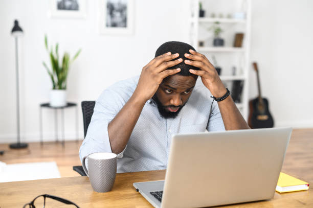 istock Puzzled upset guy looks at the screen 1314161895