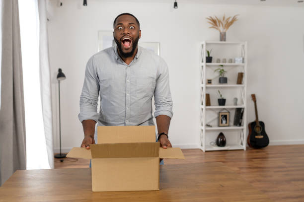 istock A guy is unpacking a parcel box at home 1314161988