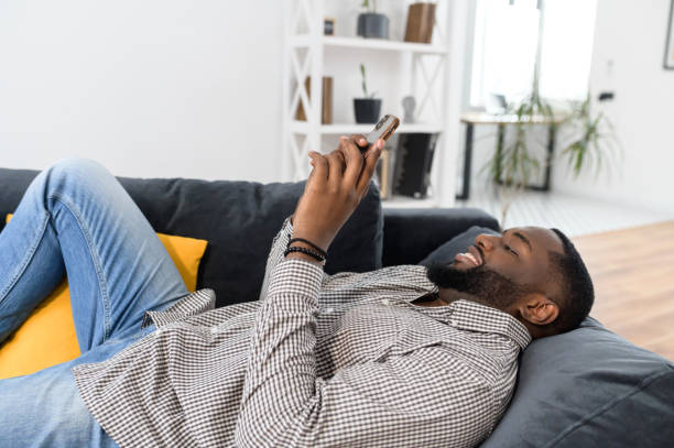 istock Millennial African American man lying on the sofa 1314162061