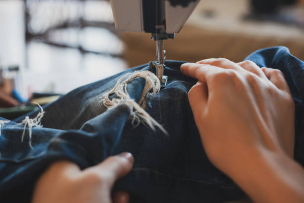 istock Young dressmaker woman sews clothes on sewing machine 1314162277