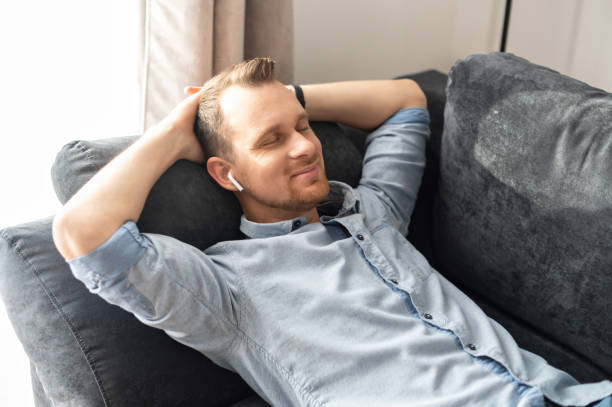 istock A smiling man rest on the couch, dreaming 1314163285