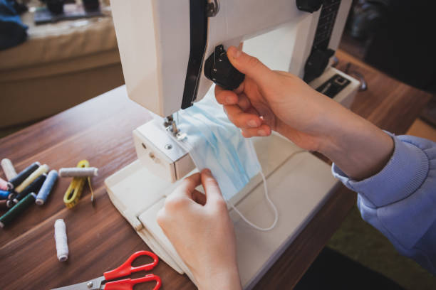 istock Young dressmaker woman sews clothes on sewing machine 1314163370